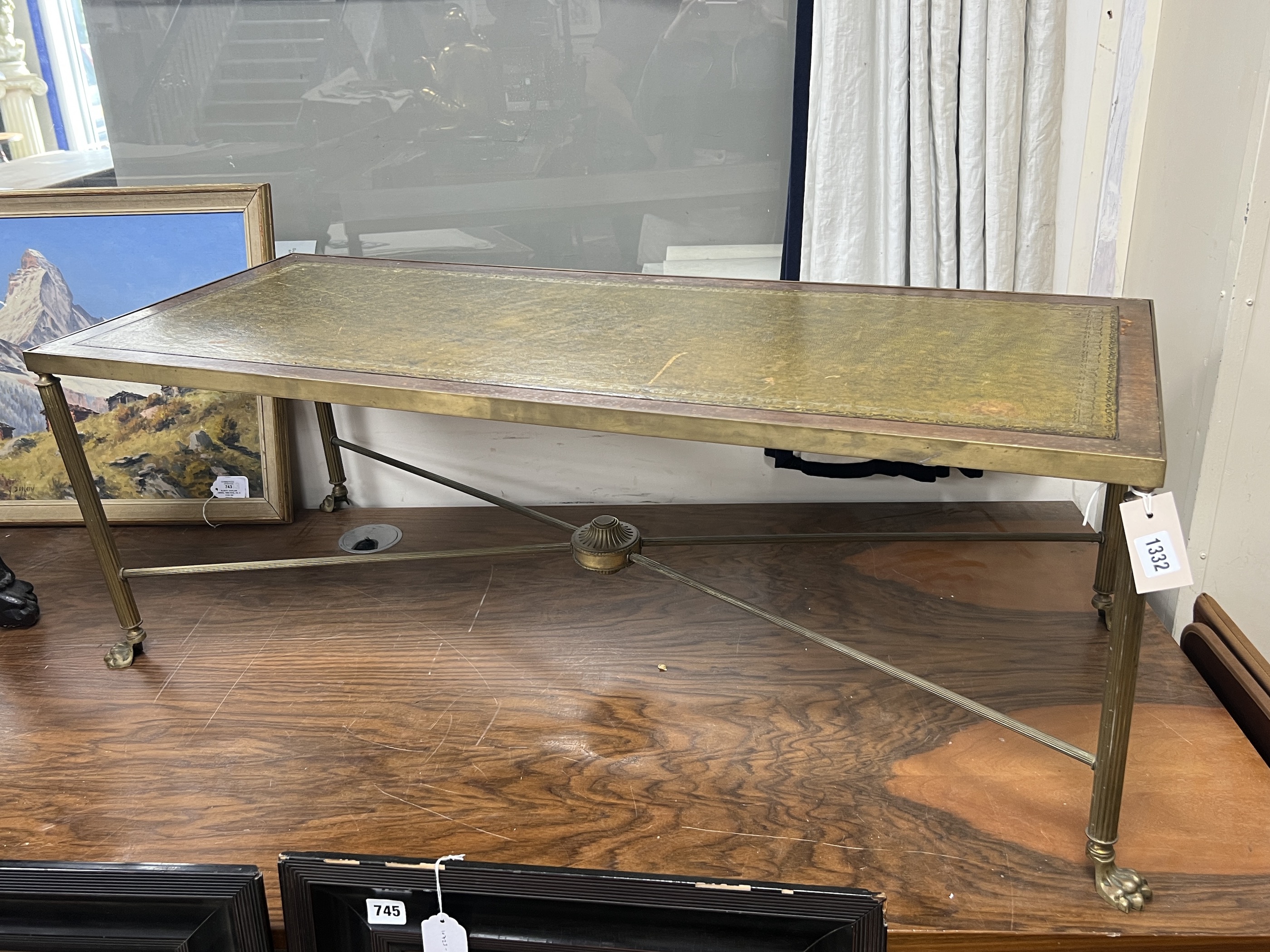 A mid century rectangular brass and mahogany leather topped coffee table with lion paw feet, width 107cm, depth 44cm, height 38cm